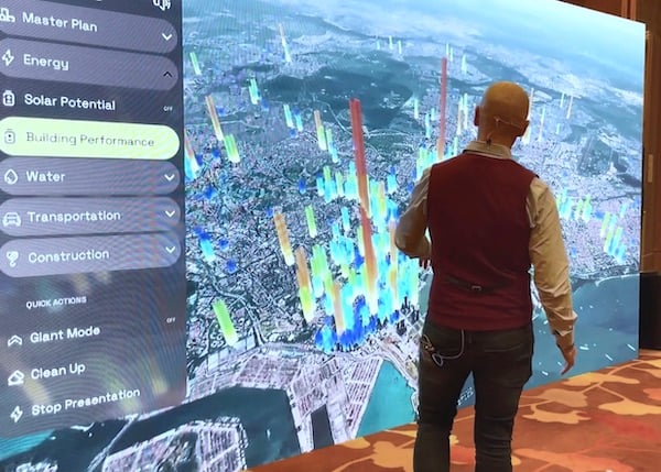 Bentley’s Greg Demchak demonstrates how energy consumption can be viewed in a digital twin with rendered vertical bars showing annual energy consumption at individual building locations.