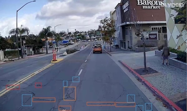 Dash-cam image with lane-edge cracking highlighted by Blyncsy model.
